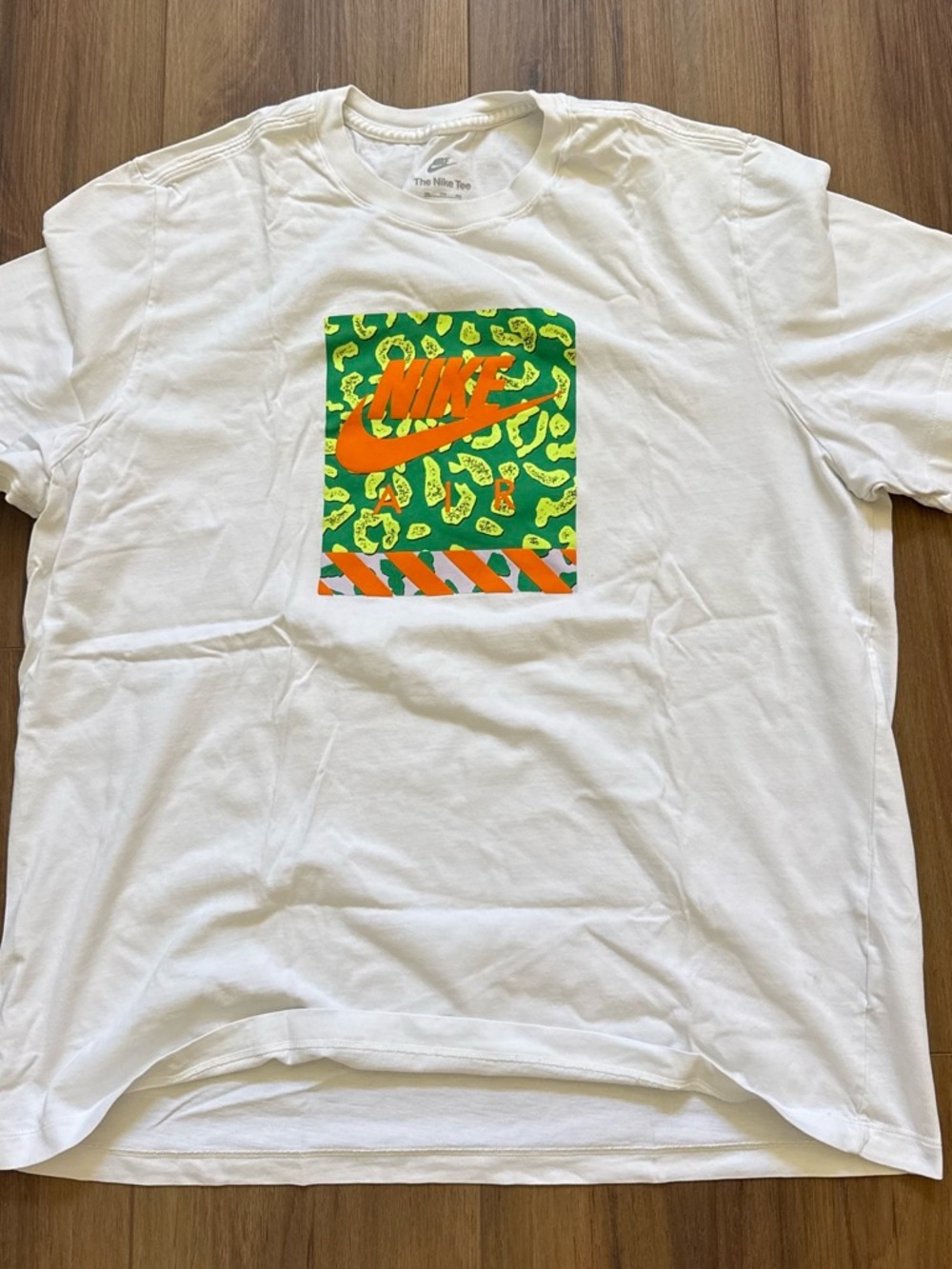 Nike White Short-Sleeve Tee with Green Leopard Graphic and Orange Swoosh